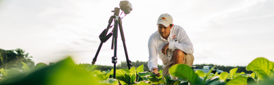 Image of man taking pictures in a field