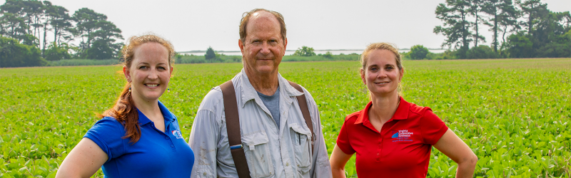 Image of farmer with two extension agents