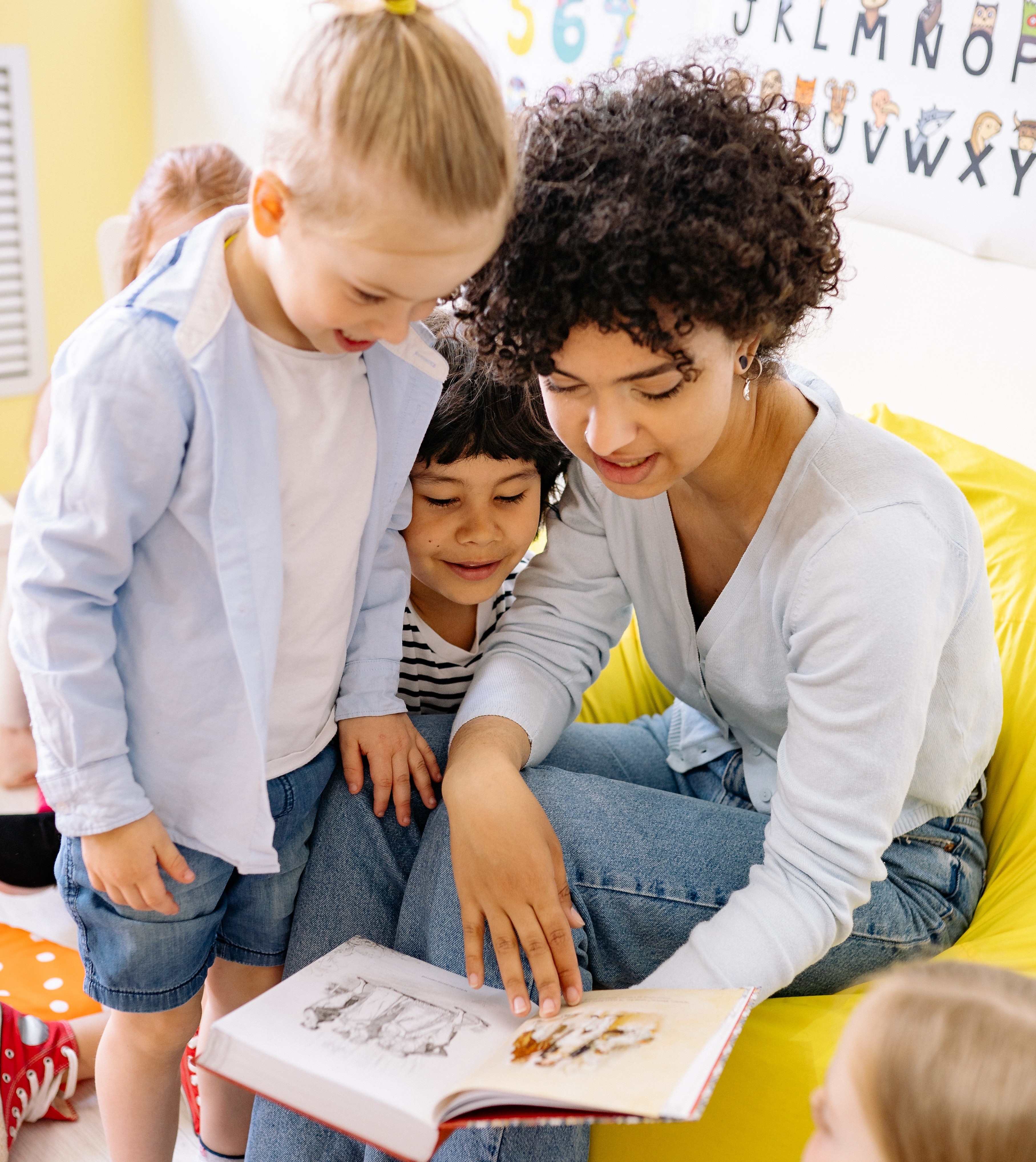 An adult helping minors with a program activity