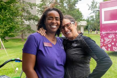 Photo of two faculty members posed together and smiling